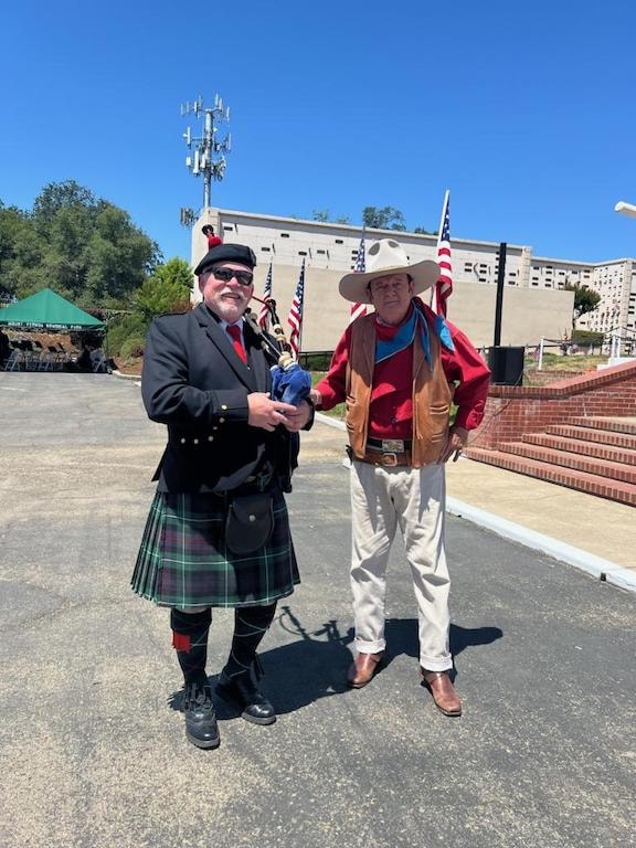 Bruce Locken in kilt with a John Wayne impersonator at a memorial